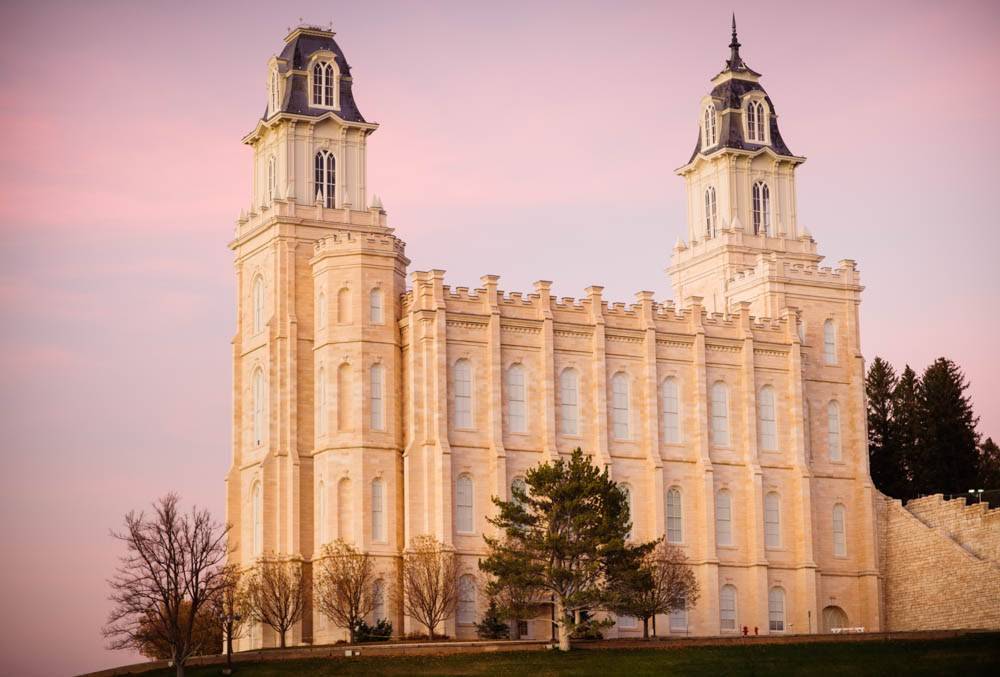 LDS art photo of the Manti Temple standing against a pink sky. 