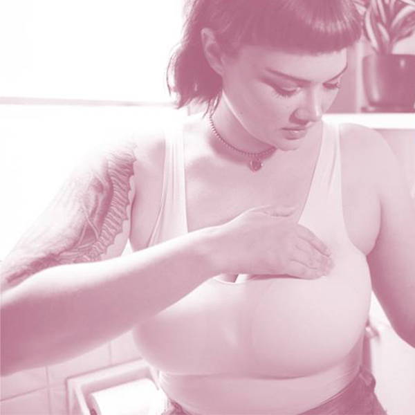 A woman doing a self check breast exam