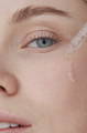 woman applying hyaluronic acid to hydrate under eye area