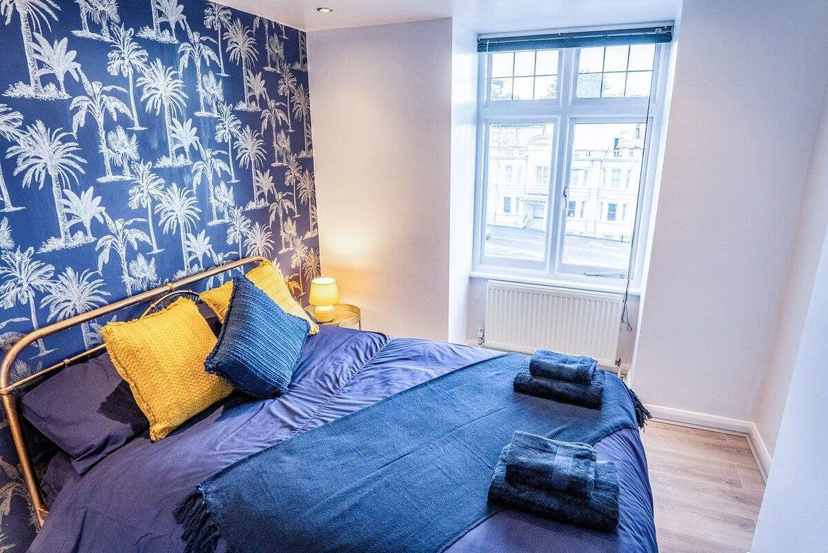 bedroom shot showing bed adjacent to the window