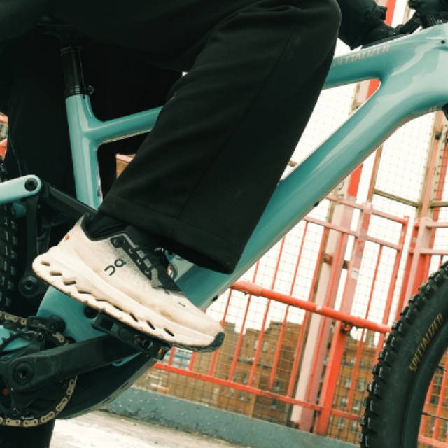 A person on a teal specialized electric mountain bike