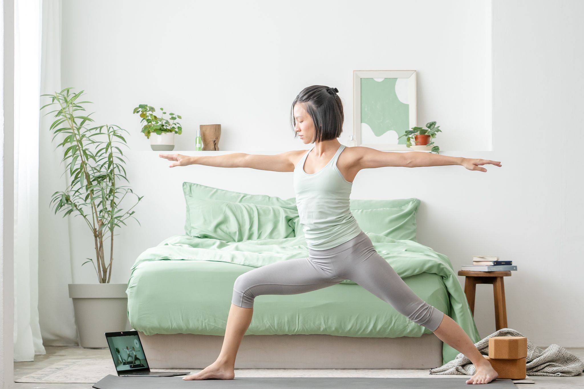 Girl doing yoga indoors healthy, featuring Weavve's tencel lyocell queen bed sheets