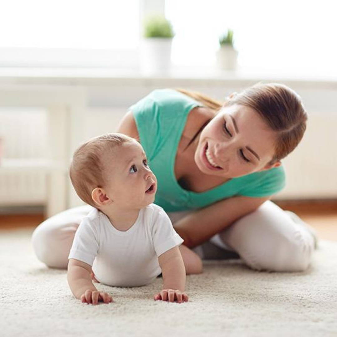 Mom encouraging baby to crawl