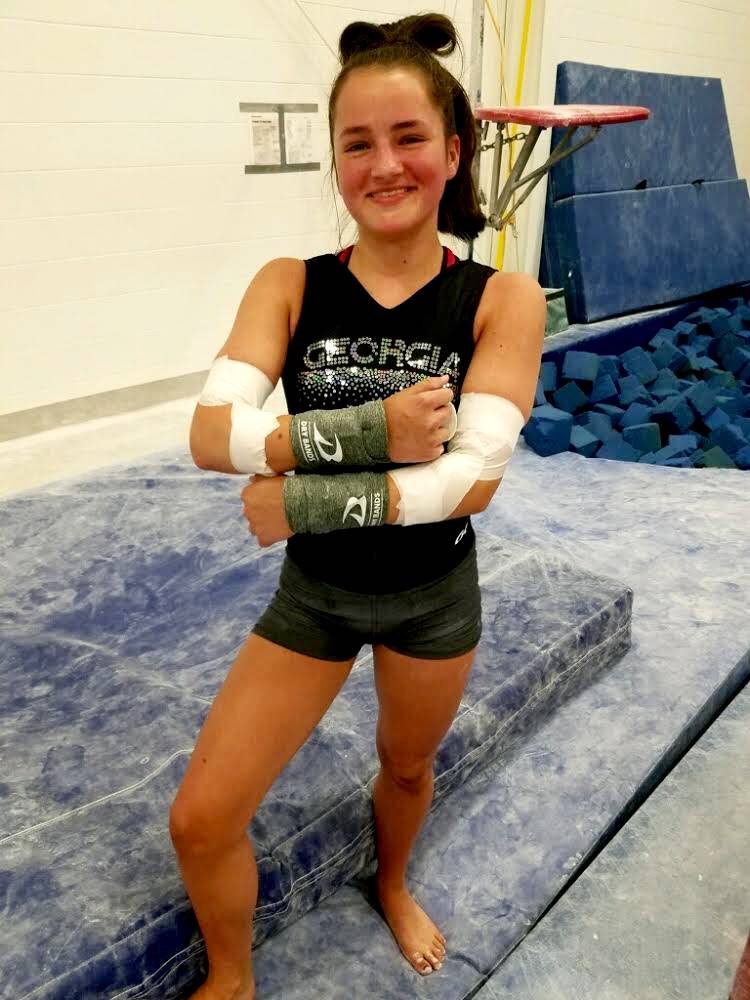 Emily wearing DRYbands with grips on again, happy to be back in the gym.