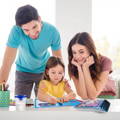 Father and mother watching her daughter play with the Montessori Magic Reusable Book. 