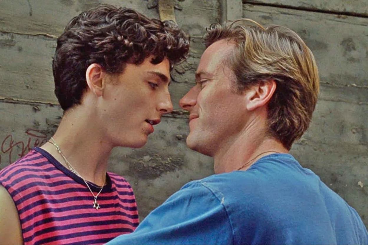 Image of the movie where Elio and Oliver are close to each other about to kiss.