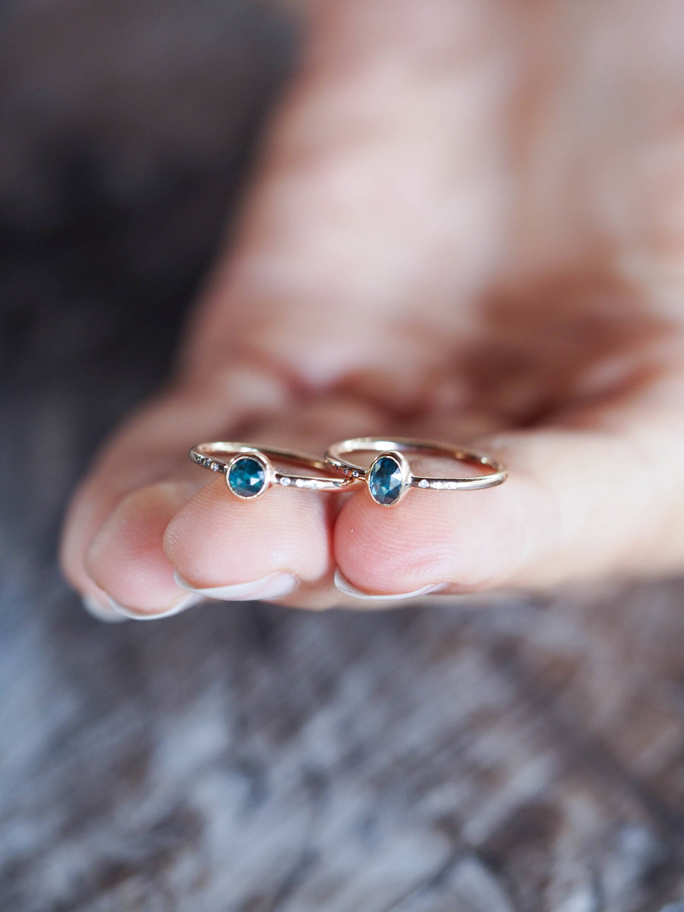 Two blue diamond rings in ethical gold