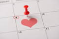 Calendar marking proposal date with a heart and pin