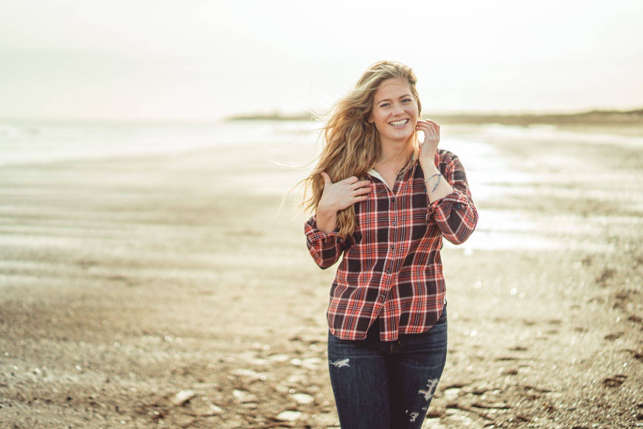 Image of abi walking along beach with wavy hair
