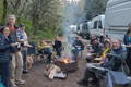 Camper Vans gathered at a campfire at sunset