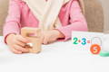Kid holding a Montessori toy learning to count