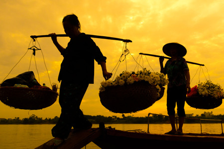 Women selling flowers on a boat in the early morning.jpg