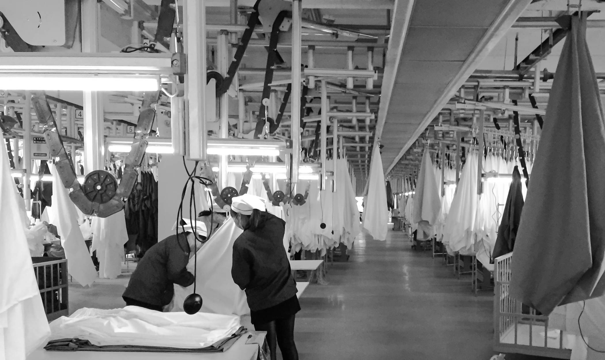 Image of workers checking on the quality of fabrics