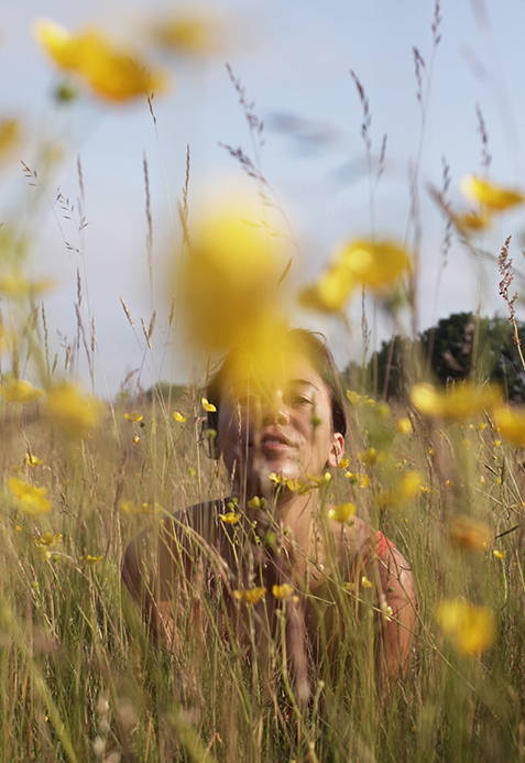 Woman in a meadow with yellow flowers