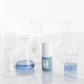 cosmetic ingredients in a laboratory including acne-fighting solutions on a white background