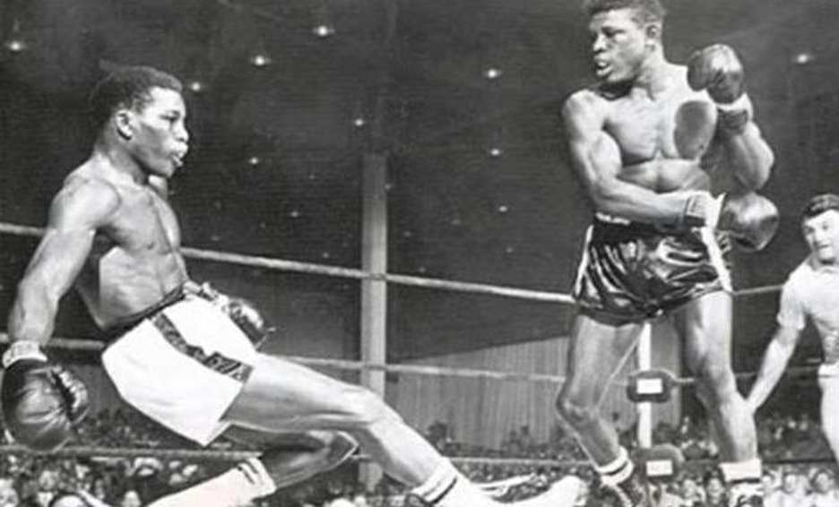 Emile during a boxing match, knocking out his opponent on his feet.