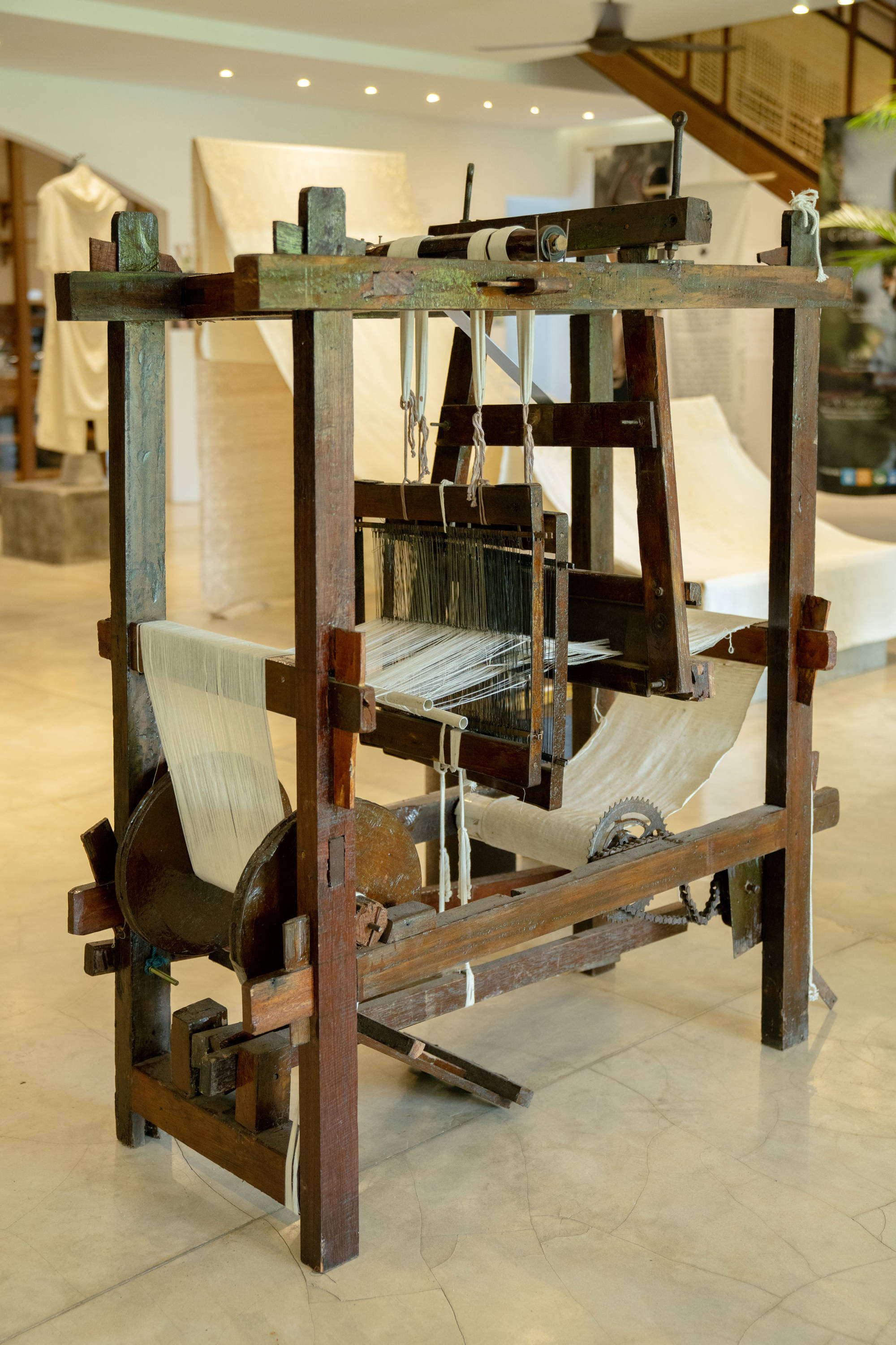 KAPAS Installation by SukkhaCitta in John Hardy Boutique & Gallery at Seminyak. A traditional weaving machine.  Regenerative cotton and natural indigo dye are used for the yarn.