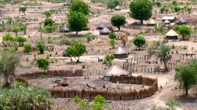 African traditional South Sudan village situated at 200 km North of the Juba City, not far away from the White Nile riverbank, view from above, horizon line.