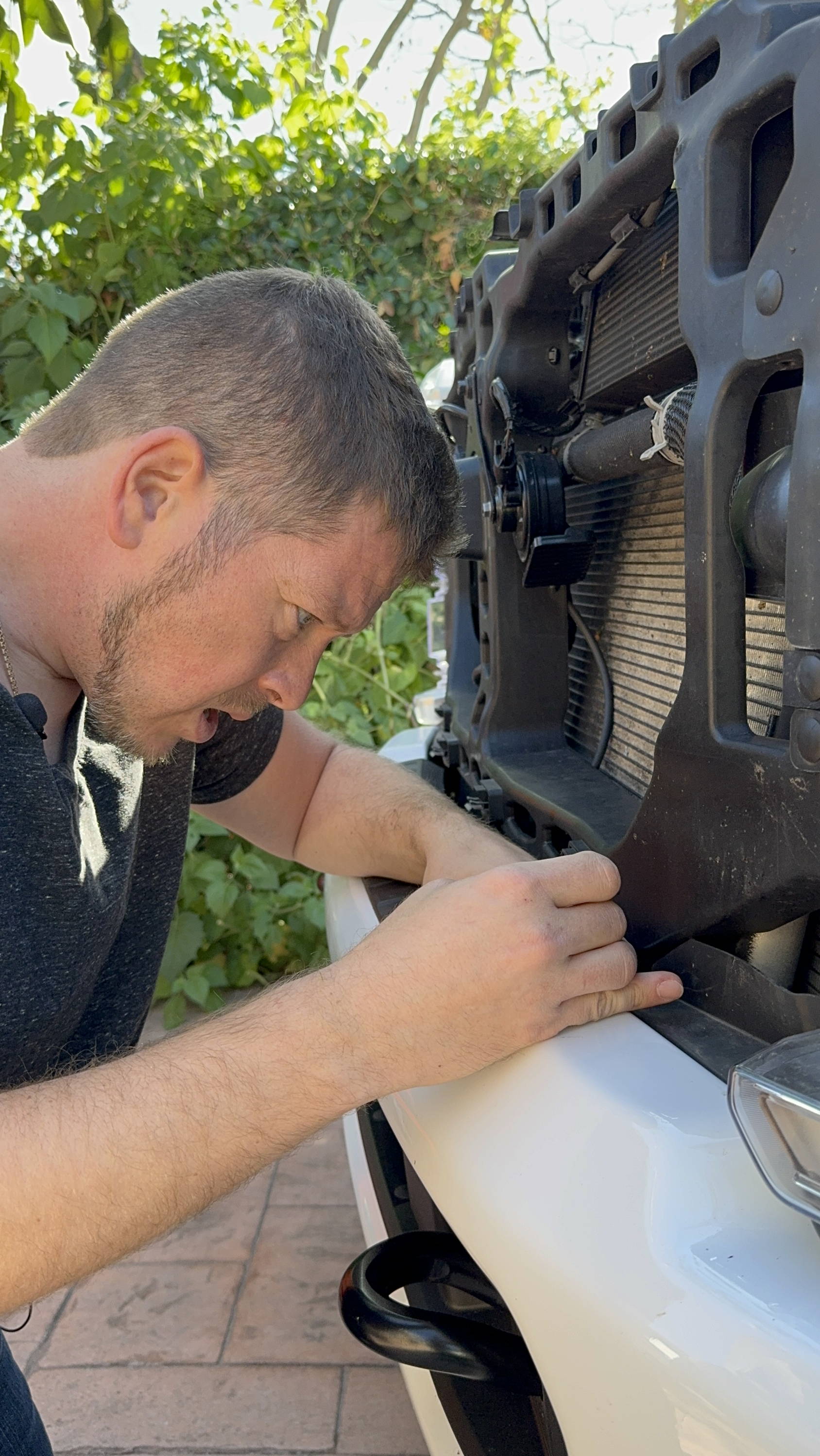 mike owner of m&R automotive installs metal brackets on ford superduty