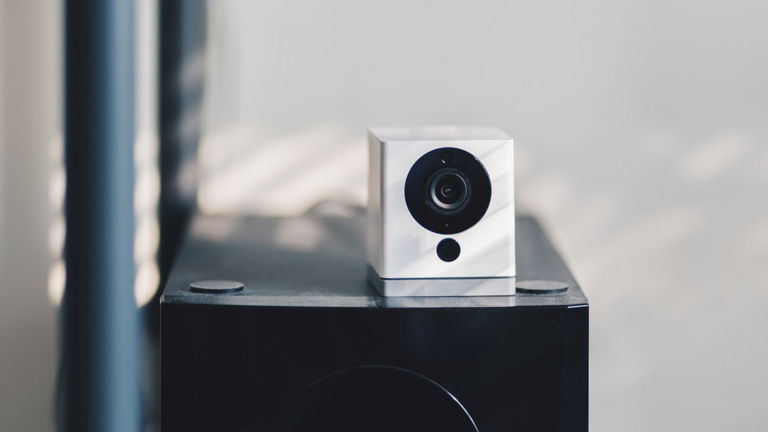 a Wyze smart security camera set on a shelf