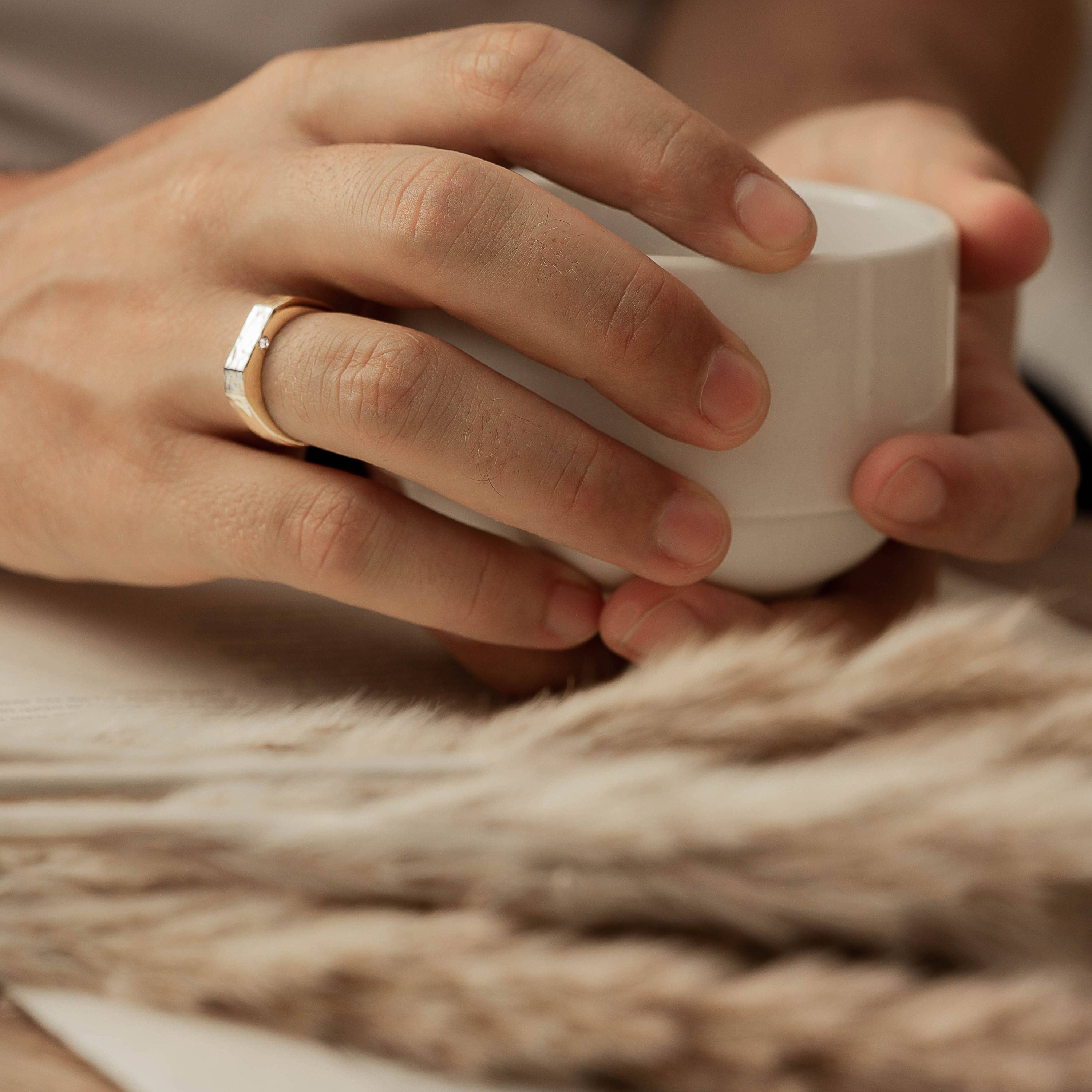 A woman's hand wearing custom jewellery piece by Sceona