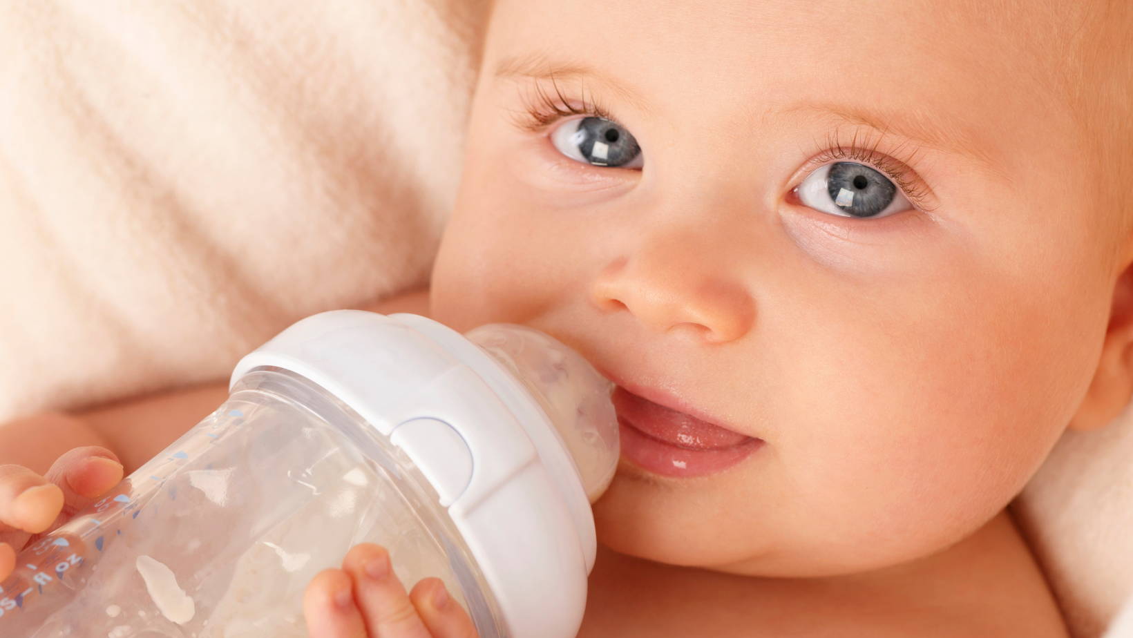 Baby holding bottle | My Organic Company