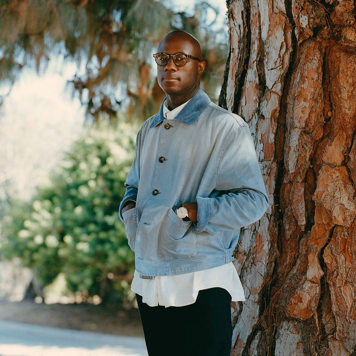 Image may contain: Barry Jenkins, Person, Standing, Clothing, Coat, Jacket, Adult, Sitting, and Sleeve