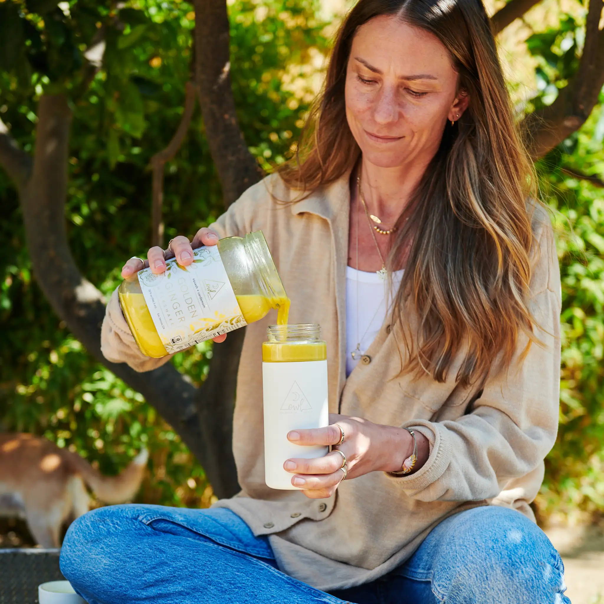 Lindsey Wilson, OWL Founder pouring Golden Ginger Mylkshake as part of Reset Cleanse for gut