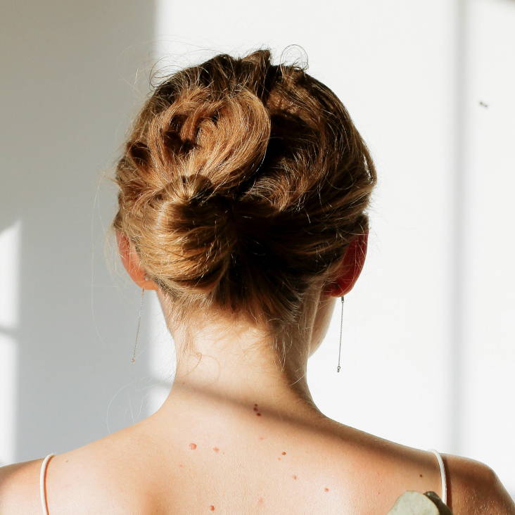 Davines model with blonde short curly hair with bangs