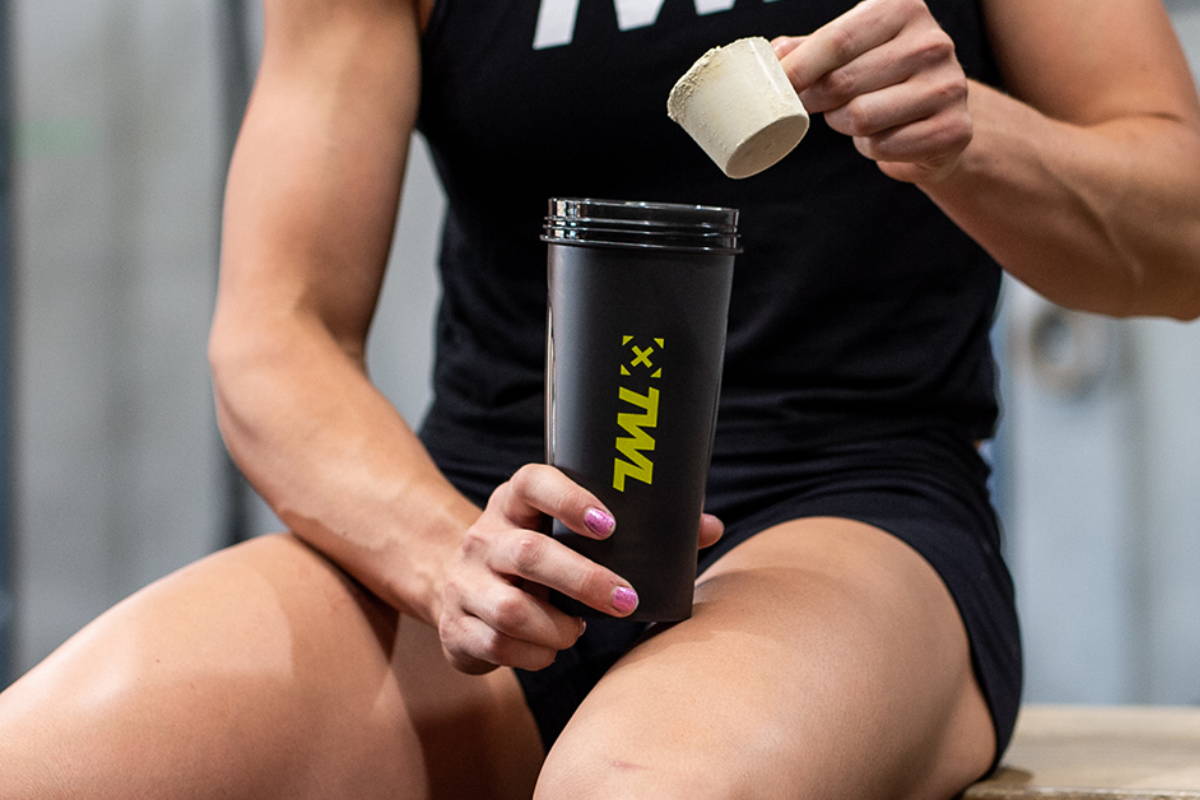 athlete making her a protein shake