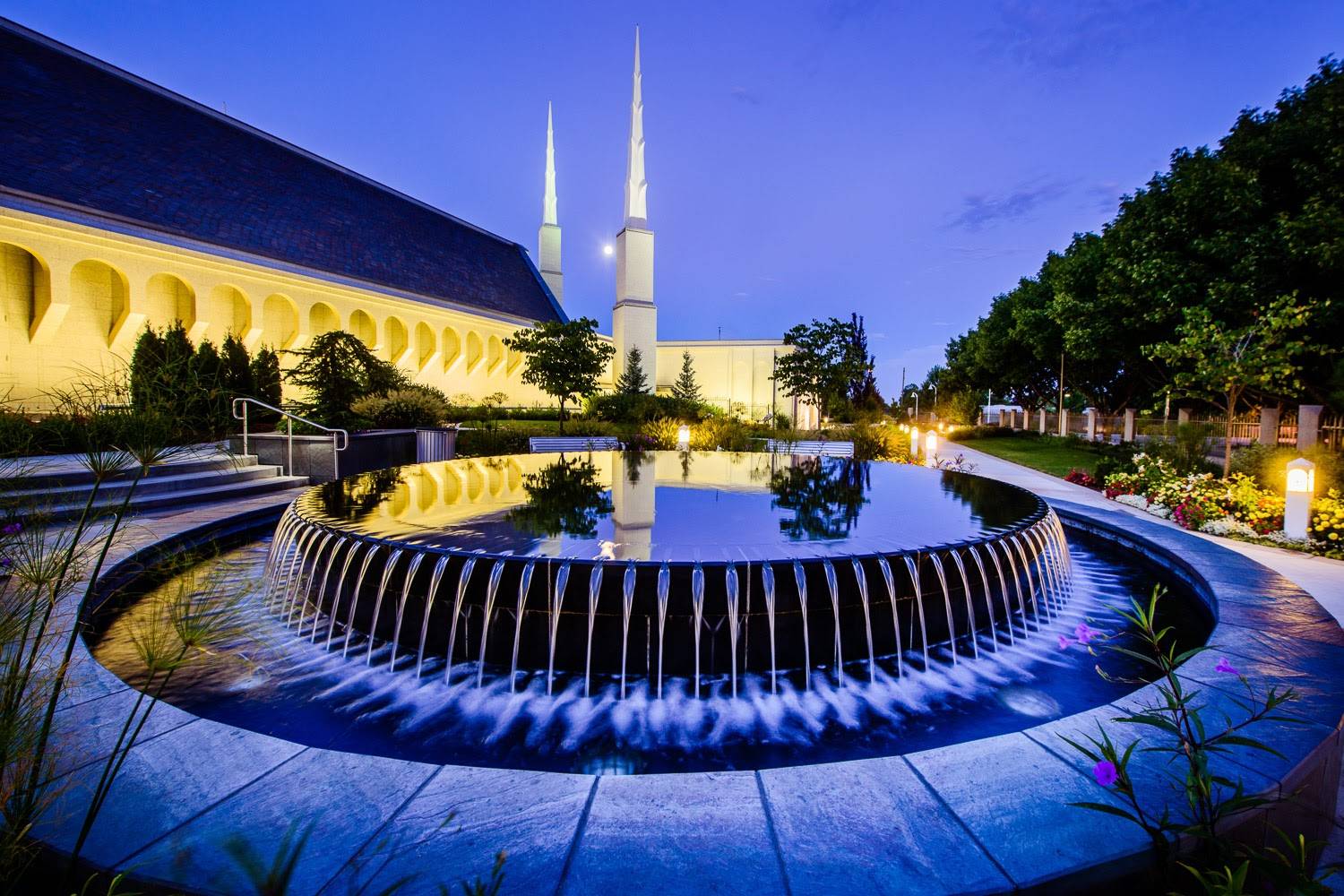 Evening photo of the Boise Temple, featuring the reflection pool fountain. 
