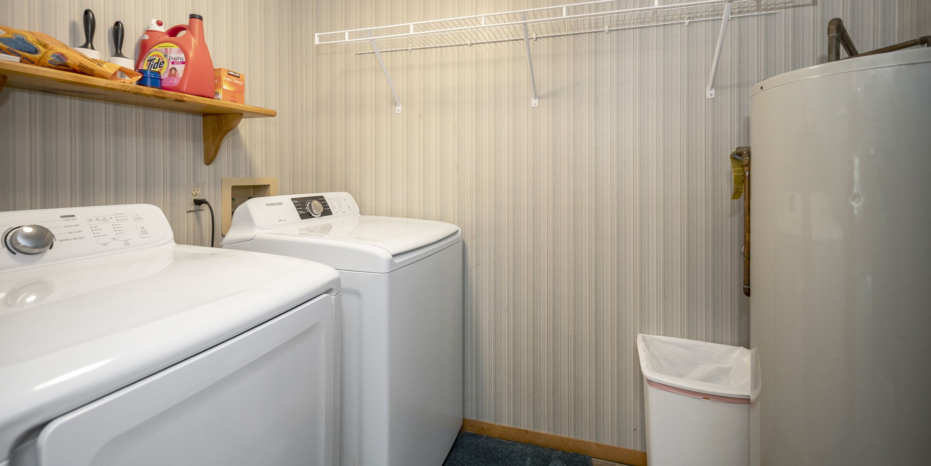 laundry room featuring water heater and separate washer and dryer