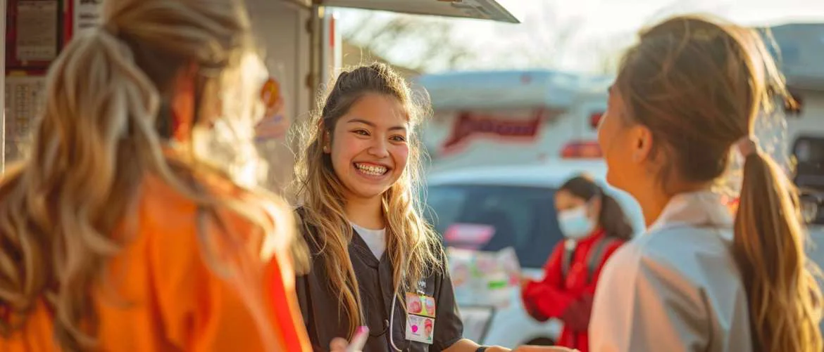 Community gathers around a mobile orthodontist’s clinic for an educational event
