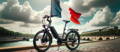 Vélo électrique conçu en France, exposé sur les bords de Seine à Paris avec un drapeau tricolore.