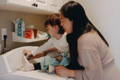 Mother and toddler doing laundry.