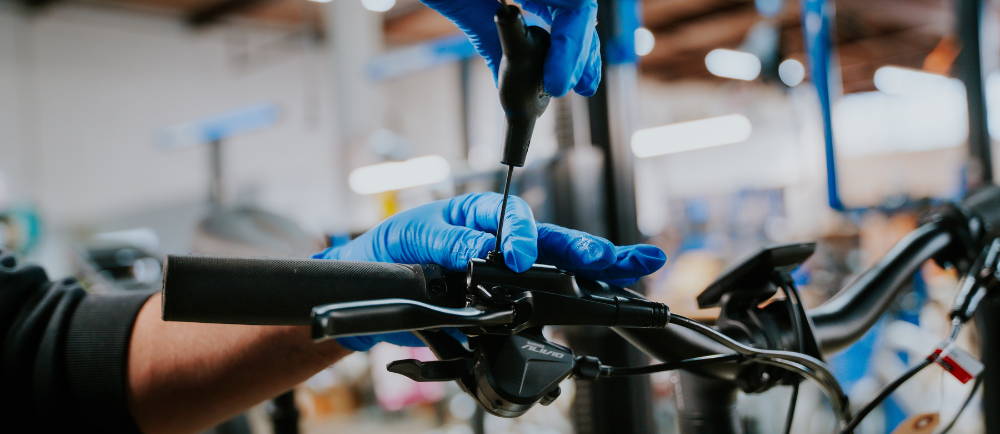 Mechanic ajusting hydraulic brakes on e-Bike