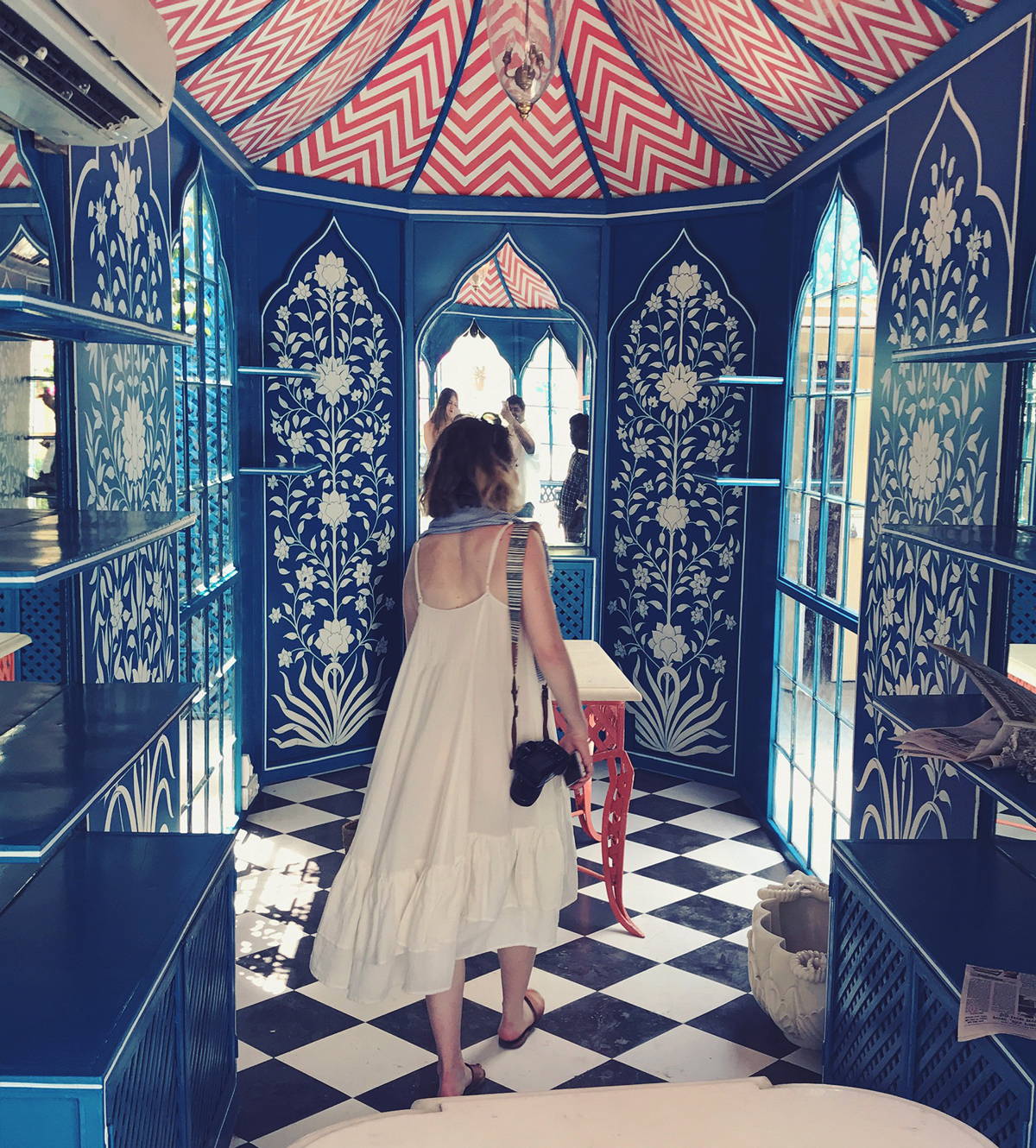 Photo of our designer Meghan in India walking through a beautiful building.