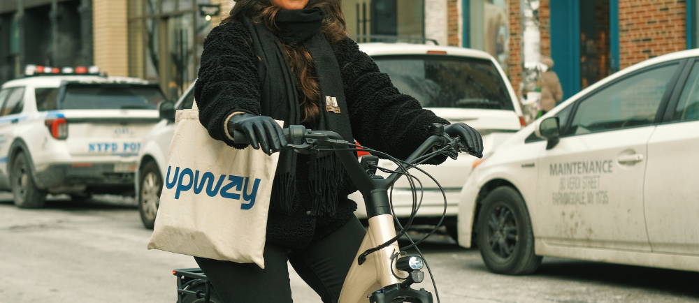 A woman riding an e-Bike on a street