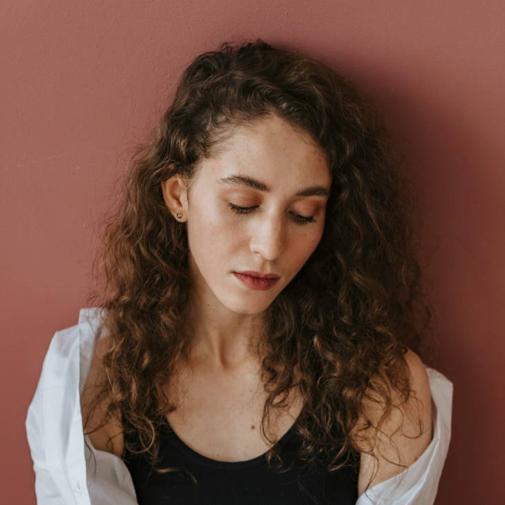 woman with curly brown hair to shoulder-length