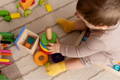 Baby boy playing with colorful wooden toys. 