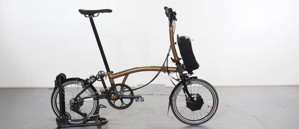 Man lifting folding electric bike into car