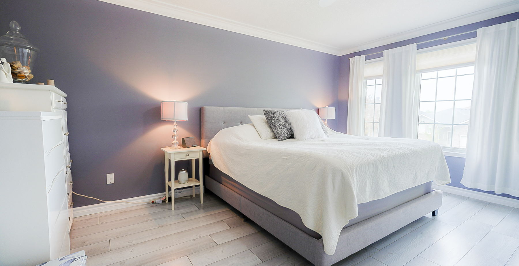 hardwood floored bedroom featuring natural light
