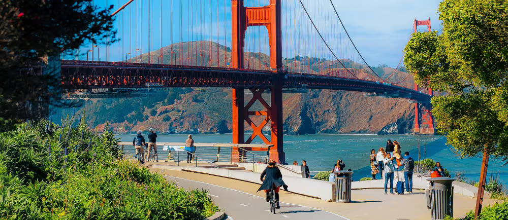 Pedestrians and cyclist in front of Golden Gate Bridge