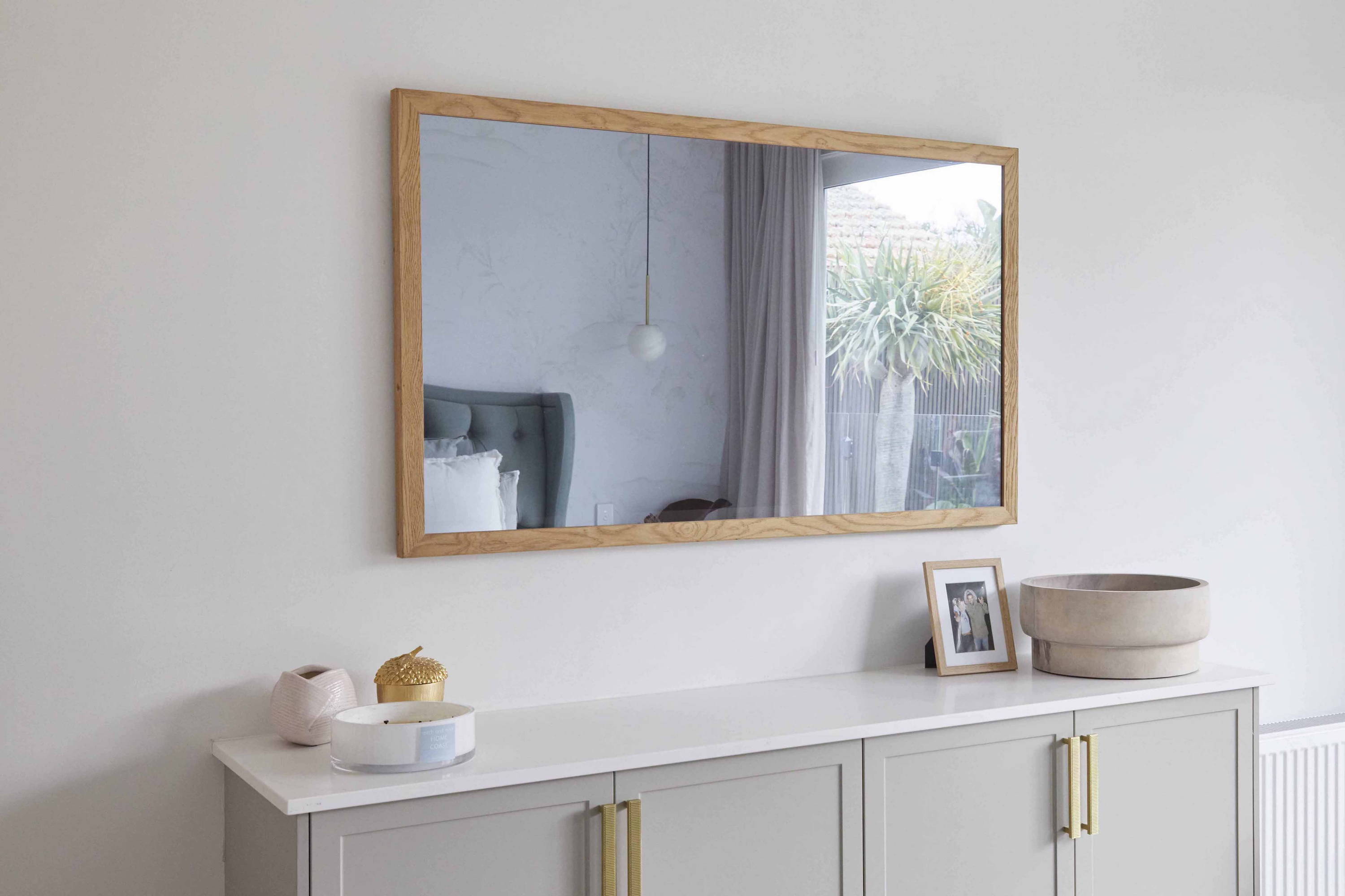 TV-Mirror Modern Rustic Oak Frame by FRAMING TO A T - A TV-Mirror with an oak frame in a light, fresh bedroom.