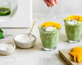 Garden matcha latte in a ceramic cup and honey and lavender on the side on a wooden tray