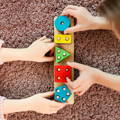 Two girls playing with wooden Montessori building blocks.