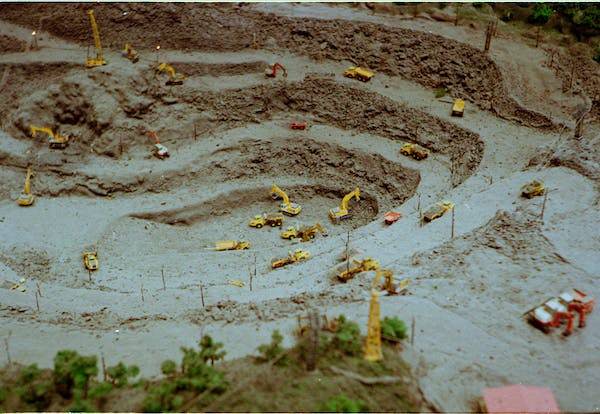 Heavy machinery working deep inside a large diamond mine