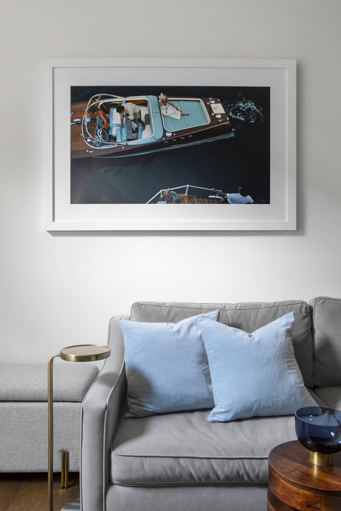A living room with framed photography above sofa