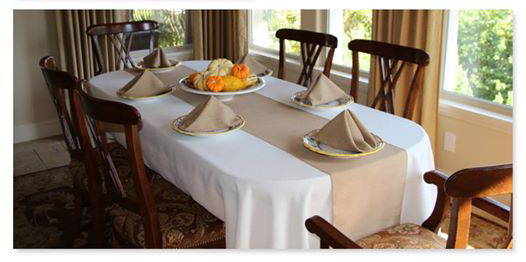 faux burlap table runner and napkins on an oval table