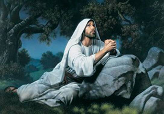 Jesus resting against a rock, hands clasped in prayer in dark Gethsemane.